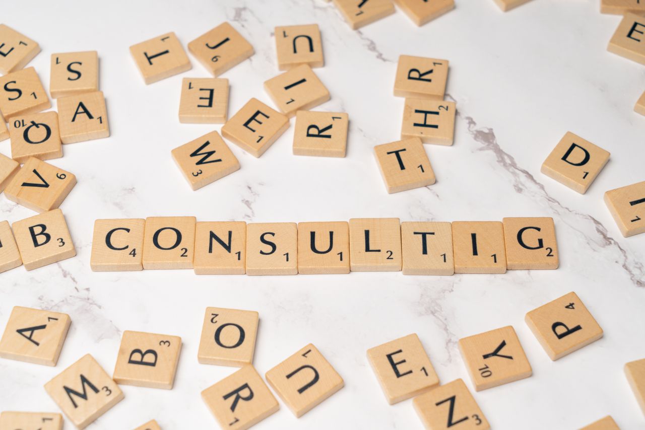 Crafting Captivating Headlines: Your awesome post title goes here Scrabble tiles spelling 'Consulting' on a stylish marble surface symbolize strategic creativity.