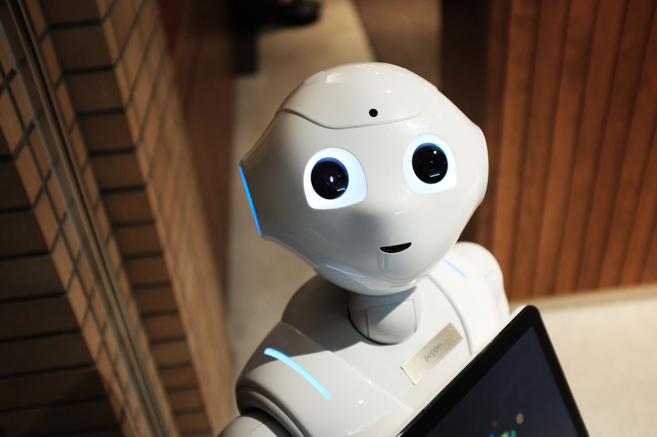services-04 A futuristic humanoid robot in an indoor Tokyo setting, showcasing modern technology.